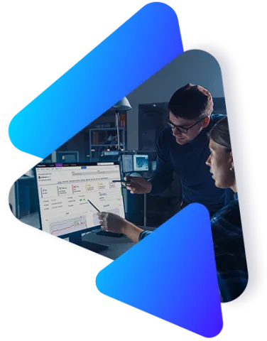 Two individuals looking at a monitor with Perforce BlazeMeter testing software dashboards